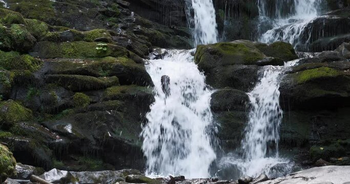 Beautiful waterfall in the mountains, wild nature of Carpathian Mountains, Western Ukraine. Cinema 4K 60fps video