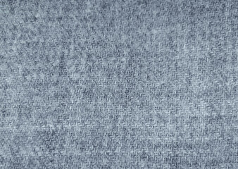 Top view over soft woolen grey textil texture scarf. Winter clothing