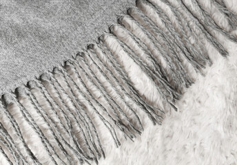 Wool warm gray scarf with fringes. Winter clothes.