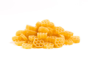 Raw Italian pasta in a heap on the table isolated on white background