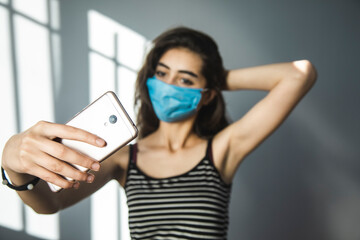 woman in mask make selfie