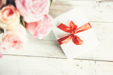 gift box and roses on the table