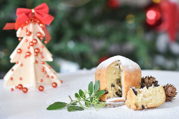 Mini Panettone (Italian Christmas cake) with candied fruit with blurred Christmas lights flashing...