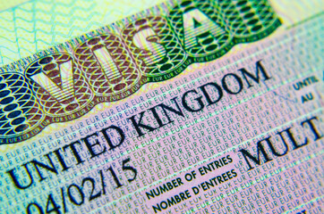 United Kingdom multiple entry Business Tourist visa sticker in a passport. Macro photo. No Sensitive information.