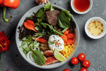 fresh healthy light breakfast, business lunch. Breakfast with poached egg, buckwheat, red fish, fresh salad, cucumbers, business lunch concept