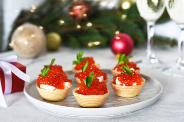 Tartlets with red caviar on the New Year's table.