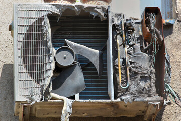 Burnt and charred air conditioner unit after a fire