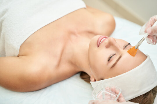 Cosmetology beauty procedure. Young woman skin care. Beautiful female person. Rejuvenation treatment. Facial chemical peel therapy. Clinical healthcare. Doctor hand. Dermatology cleanser.