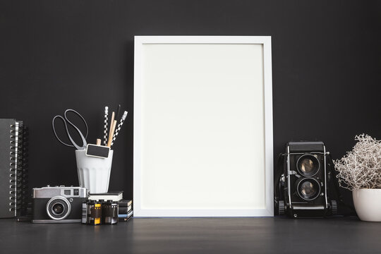 Mock Up Photo Frame On A Black Wall With Medium Format Camera.