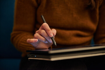 Closeup of a person writing on a tablet. Close up of a person working on a tablet. Woman working on...