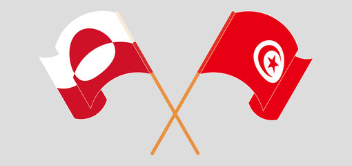 Crossed and waving flags of Greenland and Tunisia