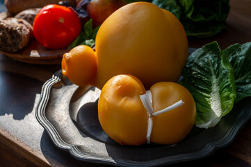 Cheese collection, Italian cheeses provolone, caciocavallo, scamorza made from sheep or cow milk in South Italy, white and yellow smoked.