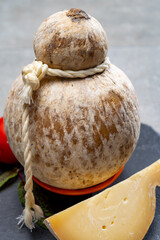 Italian semi hard matured caciocavallo cheese, handmade and aged in natural underground caves in...
