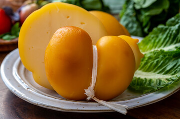 Cheese collection, Italian cheeses provolone, caciocavallo, scamorza made from sheep or cow milk in South Italy, white and yellow smoked.