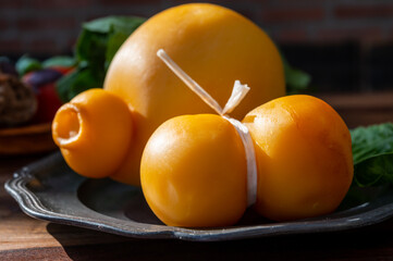 Cheese collection, Italian cheeses provolone, caciocavallo, scamorza made from sheep or cow milk in South Italy, white and yellow smoked.