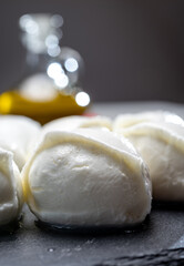 Tasty italian food, fresh white buffalo mozzarella soft cheese balls from Campania, tomatoes, fresh basil and olive oil