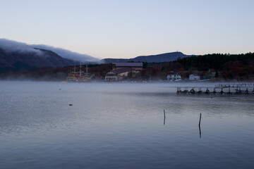 A lake in the Mt Fuji Region called, The Five Lakes, can be seen in the early morning in Autumn, It is cold and mist is rising from the water surface and frost is on the ground. Japan