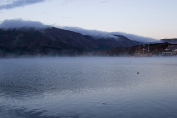 A lake in the Mt Fuji Region called, The Five Lakes, can be seen in the early morning in Autumn, It is cold and mist is rising from the water surface and frost is on the ground. Japan