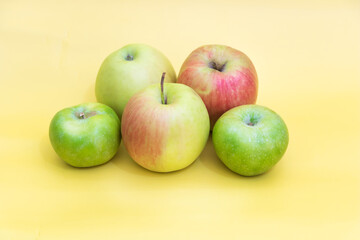 A few apples on yellow background, benefits of apples concept