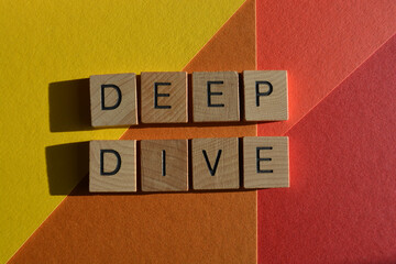 Deep Dive, words in wooden alphabet letters isolated on colourful background