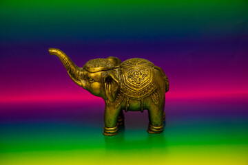 Gold elephant decoration with colorful background