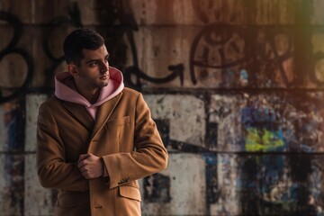 Fototapeta premium young man in coat on the street