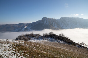 amazing winter landscape with fog and frosty trees in  Romania
