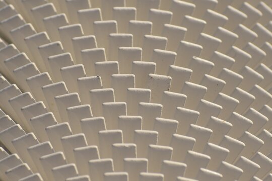 Pattern of white vanes on a heat dissipator or radiator. Part of utilities for a  northern town.