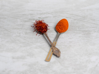 Saffron spice powder on spoons. Place for text. view from above. Food or cooking concept, bright background