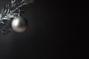 Christmas composition of fir branches and Christmas balls of viburnum on a black background isolated.