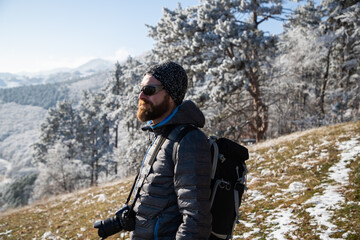 portrait of handsome man trekking in mountains in winter  outdoor adventure active lifestyle and social distancing space for your text