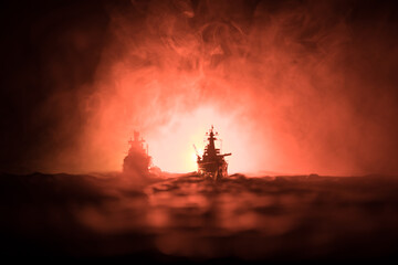 Silhouettes of a crowd standing at blurred military war ship on foggy background. Selective focus....