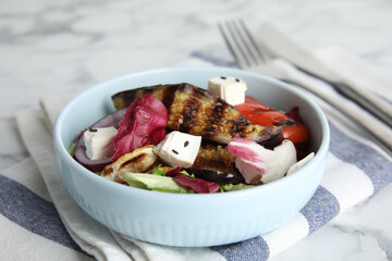 Delicious salad with roasted eggplant, feta cheese and chia seeds served on table