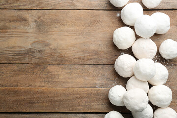 Fototapeta na wymiar Snowballs on wooden background, flat lay. Space for text