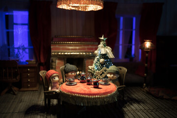 A realistic dollhouse living room with furniture and window at night. Artwork table decoration with handmade realistic dollhouse. Selective focus.