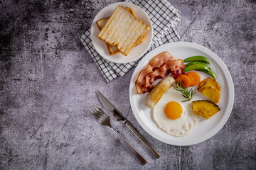 Delicious breakfast bacon, sausage, fried eggs, bread, coffee