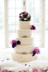 white wedding cake with fresh flowers