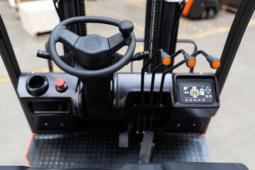 Detail of forklift cabin on warehouse. Industrial background