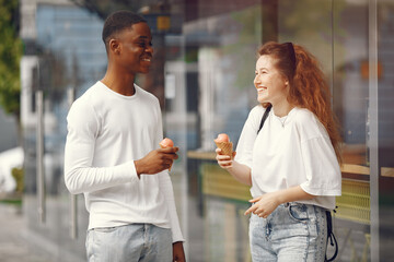 Portrait of happy mixed race couple. American woman and African American man resting together outdoors. Interracial couple concept.