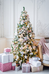 beautiful modern design of the room in delicate light colors decorated with Christmas tree and decorative elements