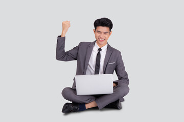 Young asian business man sitting work on laptop computer to internet online isolated on white background, businessman confident and notebook, freelance with success, marketing and communication.