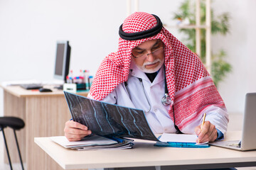 Old male arab doctor radiologist working in the clinic