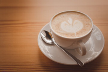 Close-up of a coffee latte on an wooden floor
