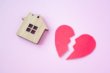 Divorce, division of property, poverty and no money concept. Wooden house with broken heart on...
