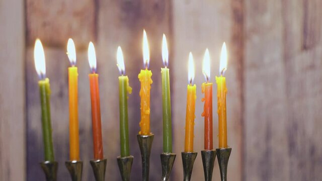 Hanukkah candles celebrating menorah with all candles burning all blurred focus