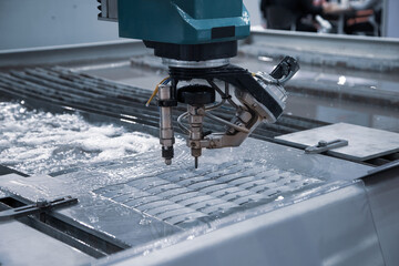 Modern CNC Abrasive water jet cutting machine using high pressure water jet to cut metal....