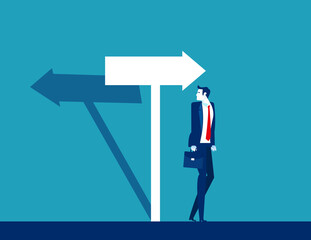 Businessman confused with the direction of the arrow sign. The arrow shadow in opposite direction