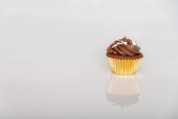 Coffee cupcake on a Gold wrapper with reflection 