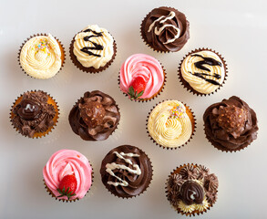 An assortment of cupcakes raging from Strawberry, chocolate, vanilla and coffee 
