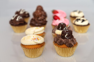 An assortment of cupcakes raging from Strawberry, chocolate, vanilla and coffee 
